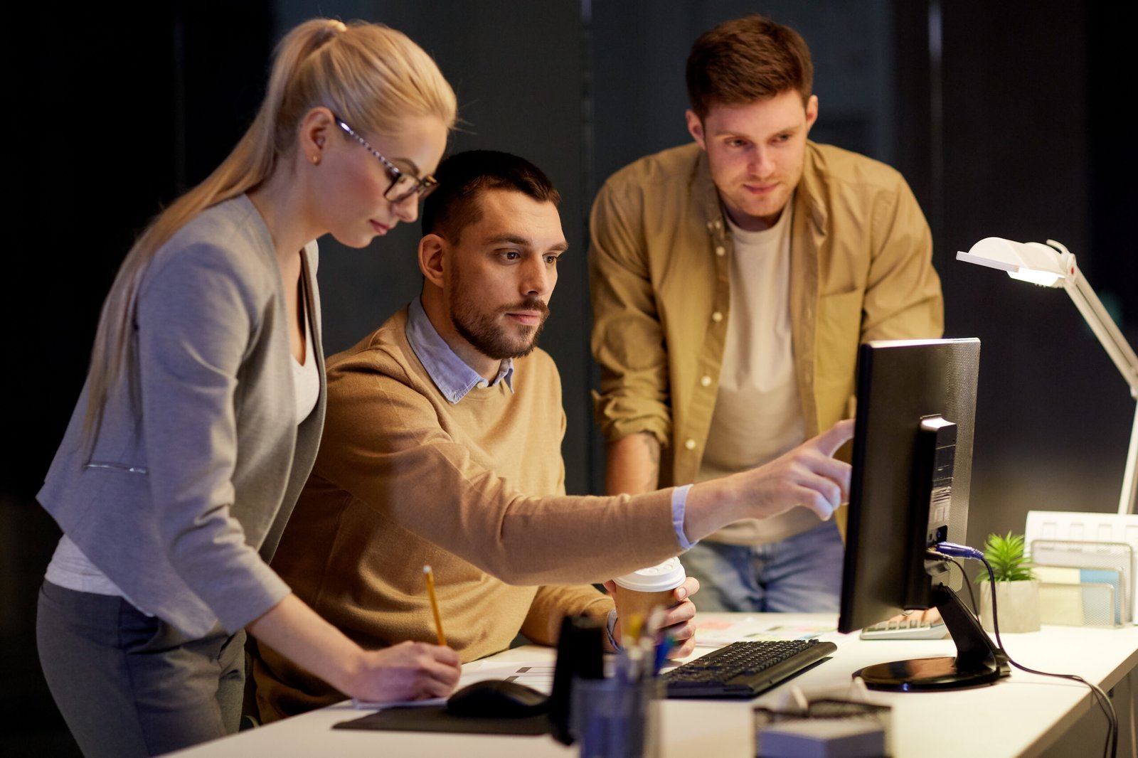 business team with computer working late office scaled