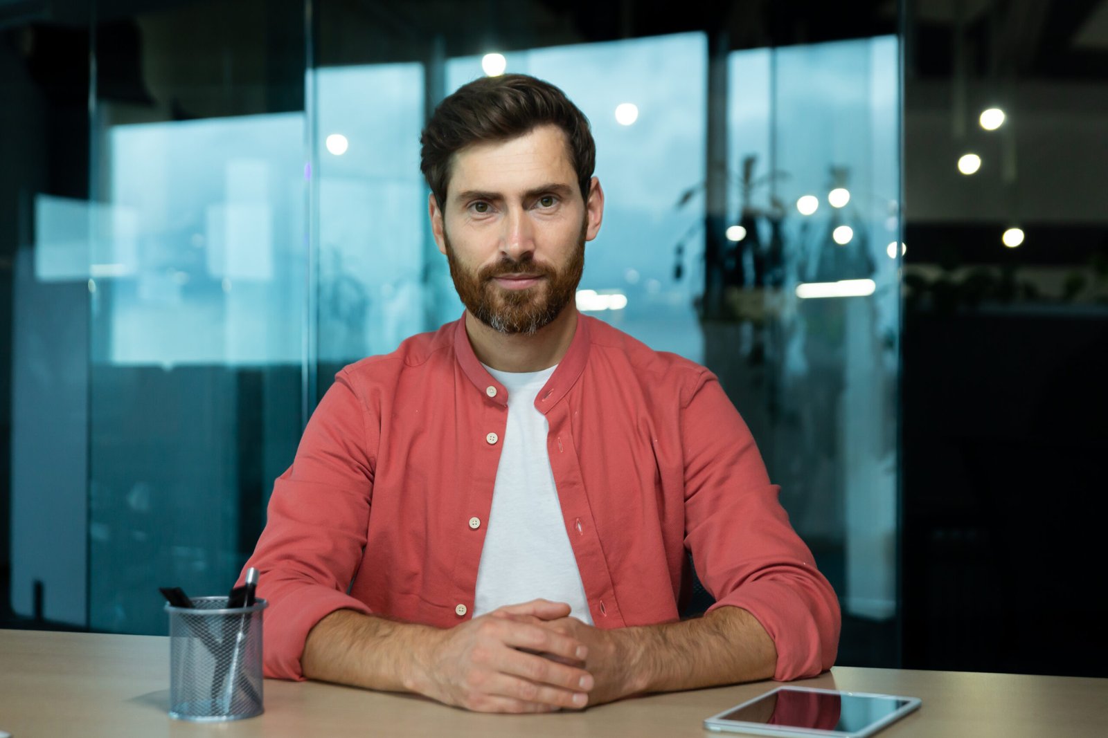 online video chat remote business meeting businessman red shirt looking seriously thinking focused into camera listening interlocutor webcam view inside office scaled